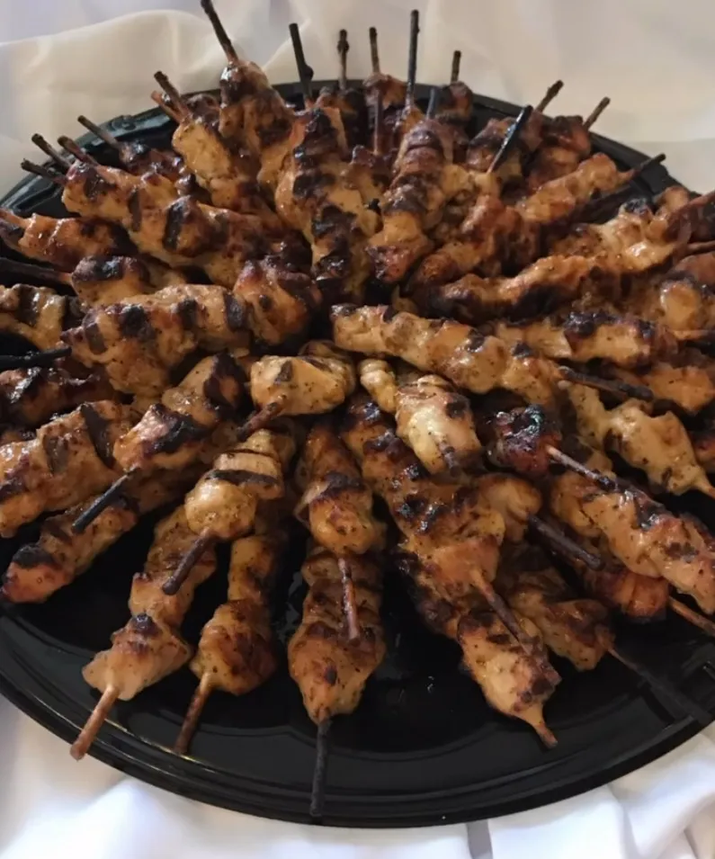 03-charred-chicken-skewers.jpg Platter of charred, spice-rubbed chicken skewers